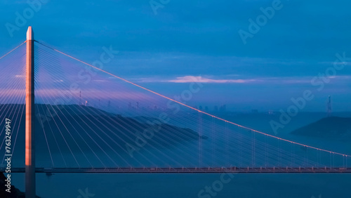 Aerial view of vehicles passing over Istanbul Yavuz Sultan Selim Bridge in sunrise light ships passing under it to enter the Bosphorus and its surroundings © Aytug Bayer