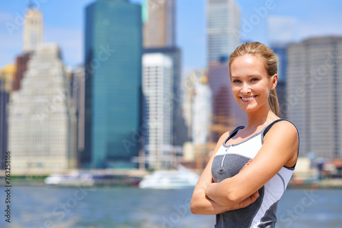 Woman, portrait and confident in city for exercise morning routine, wellness and fitness for active cardio. Female person, happy and runner or athlete for sports hobby or training workout in New York