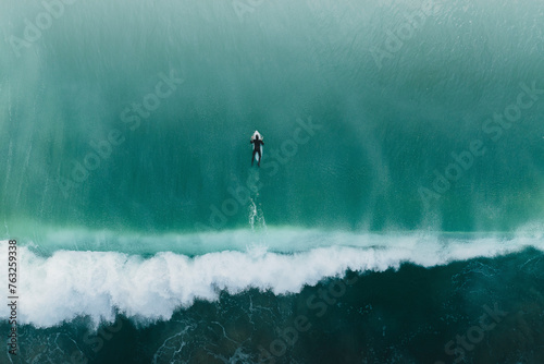 Aerial view of a surfer swimming in the sea, Peniche, portugal. photo