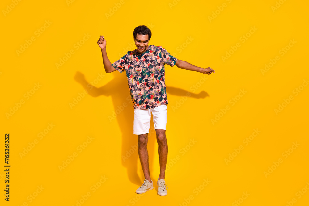 Fototapeta premium Full body length photo of carefree youngster positive man enjoying the party rhythm have fun isolated over yellow color background