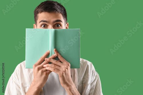 Shocked young man with book...