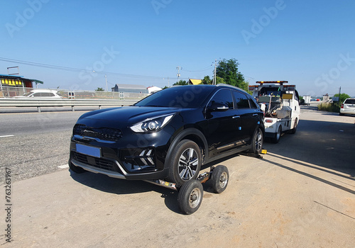 Tow Truck Towing a flat tire electric car