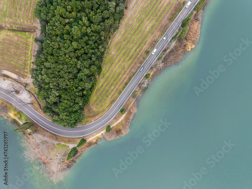 Aerial view of Toblino Lake with curvy road and vineyard, Trentino, Italy. photo