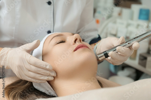 Electroporation procedure close-up. Girl on a cosmetic procedure photo