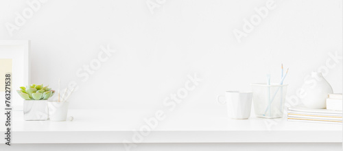 White desk with empty space. Bright stylish and minimal workspace.  