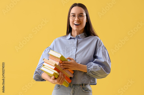 Happy young woman with stac...