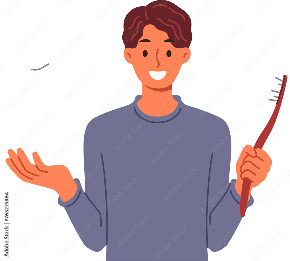 Man recommends brushing teeth well using right toothbrush to prevent caries. Guy is reminded of importance of oral hygiene and preventative control of caries by showing giant crown and brush Man recommends brushing teeth well using right toothbrush to prevent caries. Guy is reminded of importance of oral hygiene and preventative control of caries by showing giant crown and brush
