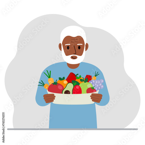 A man with a large plate of healthy organic food - vegetables and fruits. The concept of healthy food, healthy lifestyle, vegetarianism, agriculture.