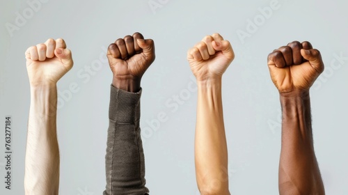 Hands of different people, of diverse race, skin color, gender raising fists up over grey background. Human rights and equality. Concept of human relation, community, togetherness, symbolism, culture 