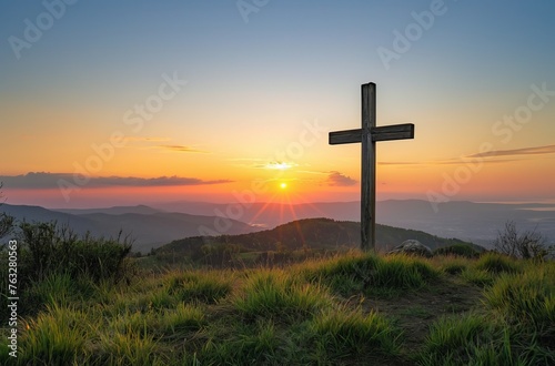 Sunset behind hilltop cross