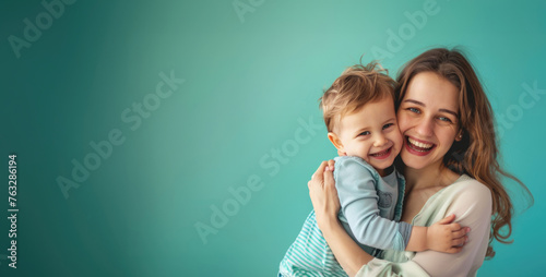 Mother Hugging Son Isolated On a Blue Background, Wallpaper With Copy Space, Studio Photo