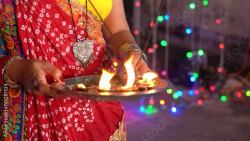 Indian Women in Traditional Attire Sari Performing Aarti to worshiping hindu god, Hindu Rituals of doing Aarti prayer, Diwali background photo