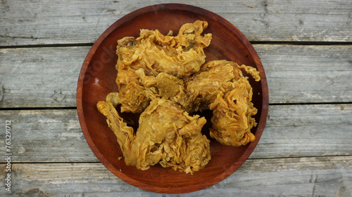 crispy kentucky fried chicken in a wooden table. Isolated on Grey background. photo