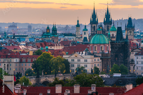 The cityscape of Prague listed in Unesco with Church of Our Lady before Tyn and Charles Bridge in the dawn.  photo