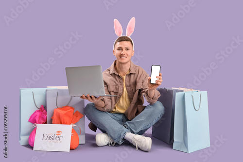 Young man in bunny ears wit...