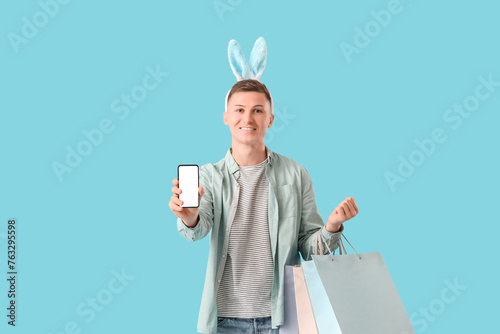 Young man in bunny ears wit...