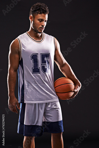 Man, sports and basketball player in studio for training, competition and fitness on black background. Professional athlete, career and exercise with ball for game, hobby and healthy model in mockup