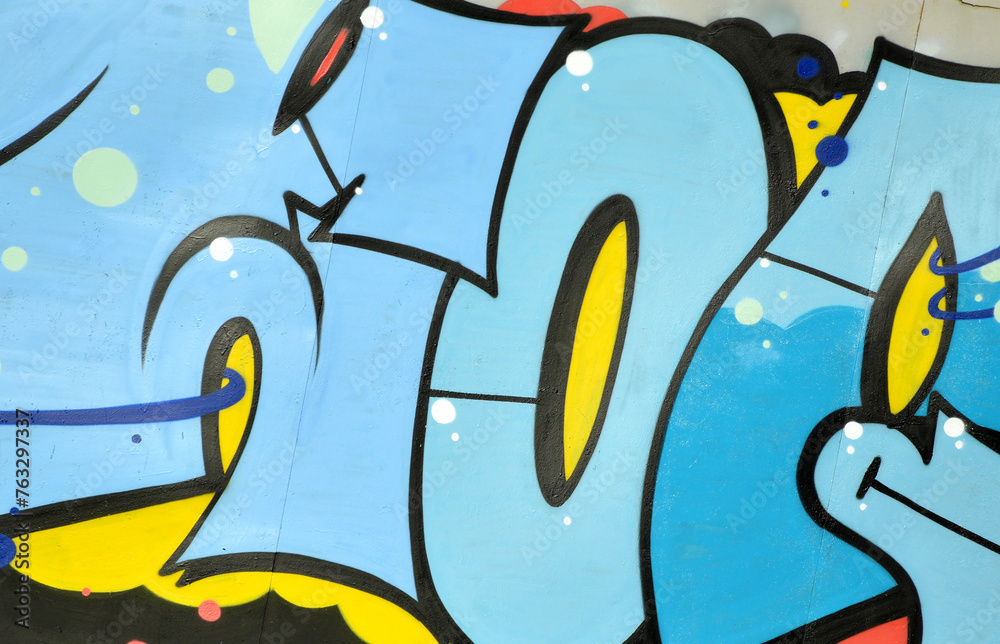 Fototapeta premium Colorful background of graffiti painting artwork with bright aerosol outlines on wall. Old school street art piece made with aerosol spray paint cans. Contemporary youth culture backdrop