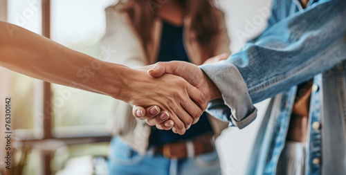 Intimate photograph of a handshake with warm sunlight casting a glow on the scene