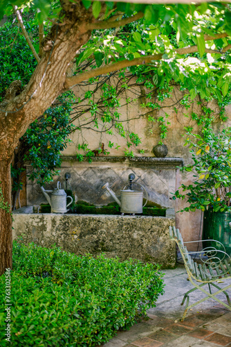 watering cans in courtyard provence