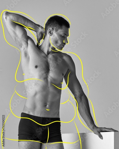 Progress in weight loss goals. Full-length image of muscular young man with overlined body in underwear. Black and white. Concept of body and health care, wellness, body-positivity, diet and sport photo