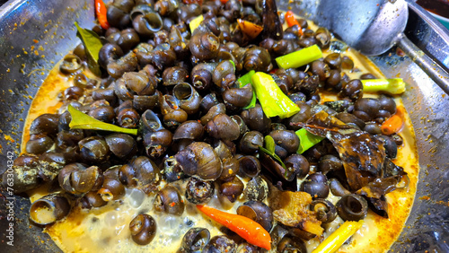 Fototapeta Naklejka Na Ścianę i Meble -  Tutut Stew, Traditional Food from Indonesia, Made from Tutut is a kind of freshwater slug. often consumed as a source of protein, This food popular in West Java, easy to find during ramadhan.