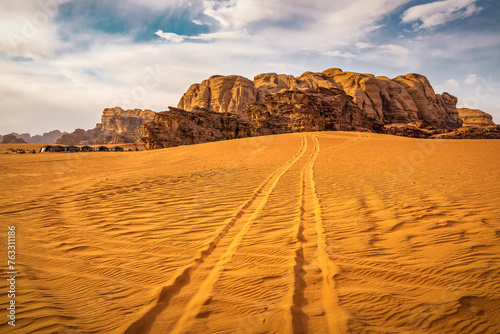 Car tire tracks on sand desert. Wadi Rum, Arabian, Kalahari or Sahara