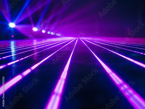 Purple laser light shines on dance floor.