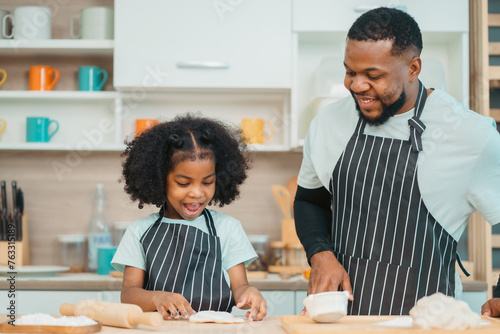 happy child family with father or mother cooking fun together for bakery bread meal in kitchen, young African little kid daughter girl and parent in love childhood lifestyle at home for food homemade