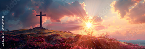 Silhouette of a cross on a hill with sun rays, depicting Easter resurrection concept