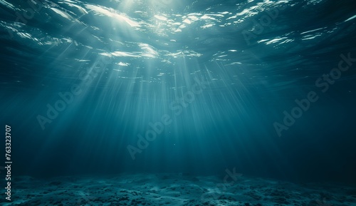 Underwater view of ocean floor with sunlight filtering through,a serene and tranquil scene.