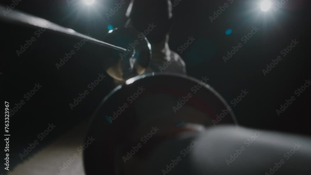 POV footage of holding fencing rapier and blocking partners strikes and riposting during duel in dark room