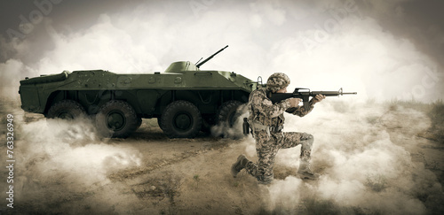 Armed soldier in smoke near armored fighting vehicle outdoors. Banner design photo