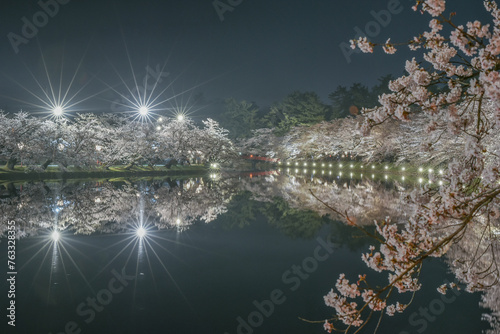 Landscape Night View Of Cherry Blossoms (Sakura) With River and Bridge Reflaction At Hirosaki Cherry Blossom Festival © weniliou