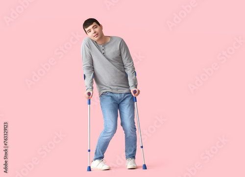 Young man with crutches on ...