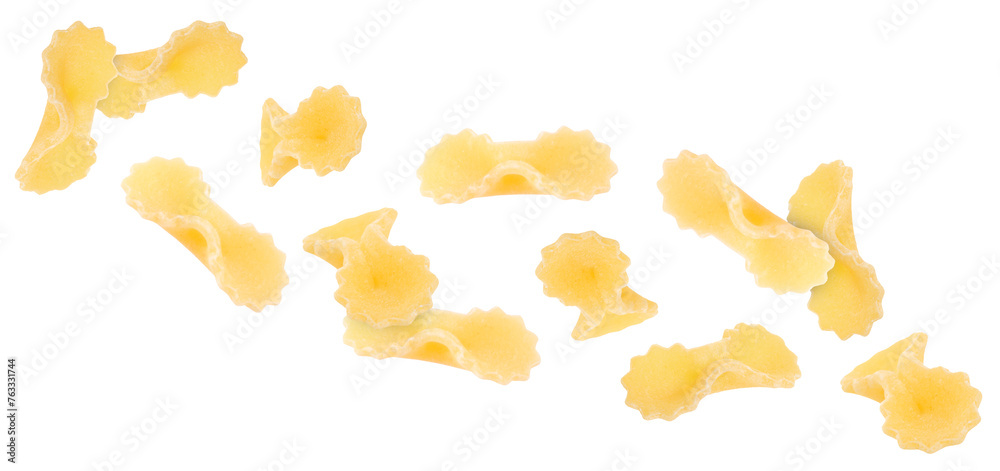 Naklejka premium Raw farfalline pasta falling on white background