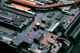 Electronic components on a computer graphics card. Bitcoin Cryptocurrency coin on a PC computer motherboard, cryptocurrency mining concept
