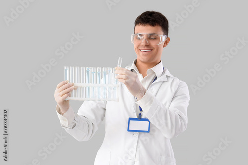 Male chemist with test tube...