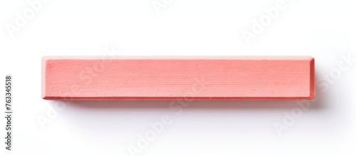 Pink wooden block on white surface
