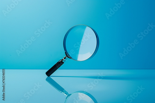 Magnifying Glass With a Black Handle Over Blue Background