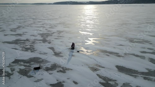 Wallpaper Mural A man sits on the ice on a winter day. A man catches fish from the ice. Torontodigital.ca