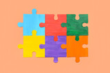 Color puzzle on beige background. Concept of autistic disorder
