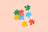 Color puzzle on beige background. Concept of autistic disorder