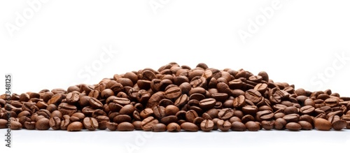 Pile of coffee beans on white surface