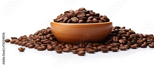 Bowl filled with roasted coffee beans on white background © Ilgun