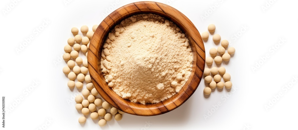 Wooden bowl filled with white beans beside a pile of beans Wooden bowl filled with white beans beside a pile of beans