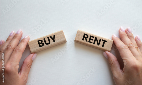 Buy or Rent symbol. Concept word Buy or Rent on wooden blocks. Businessman hand. Beautiful white background. Business and Buy or Rent concept. Copy space