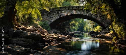 Stone bridge over river with trees and rocks