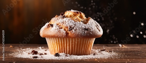 A muffin with powdered suga...
