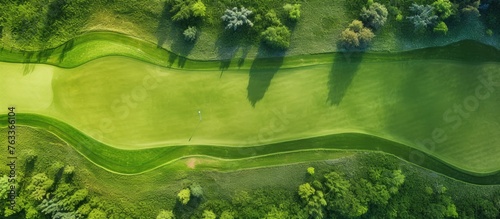 Aerial view of a lush golf course with greenery and trees